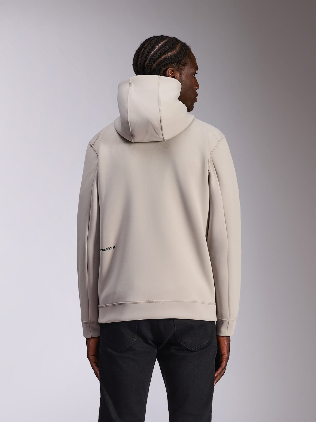 Alpinestars Cypher Hoodie, casual sportswear, Cement gray, back view on model, high-neck hood, double-face fleece material, minimal Alpinestars logo on the lower back, paired with black pants
