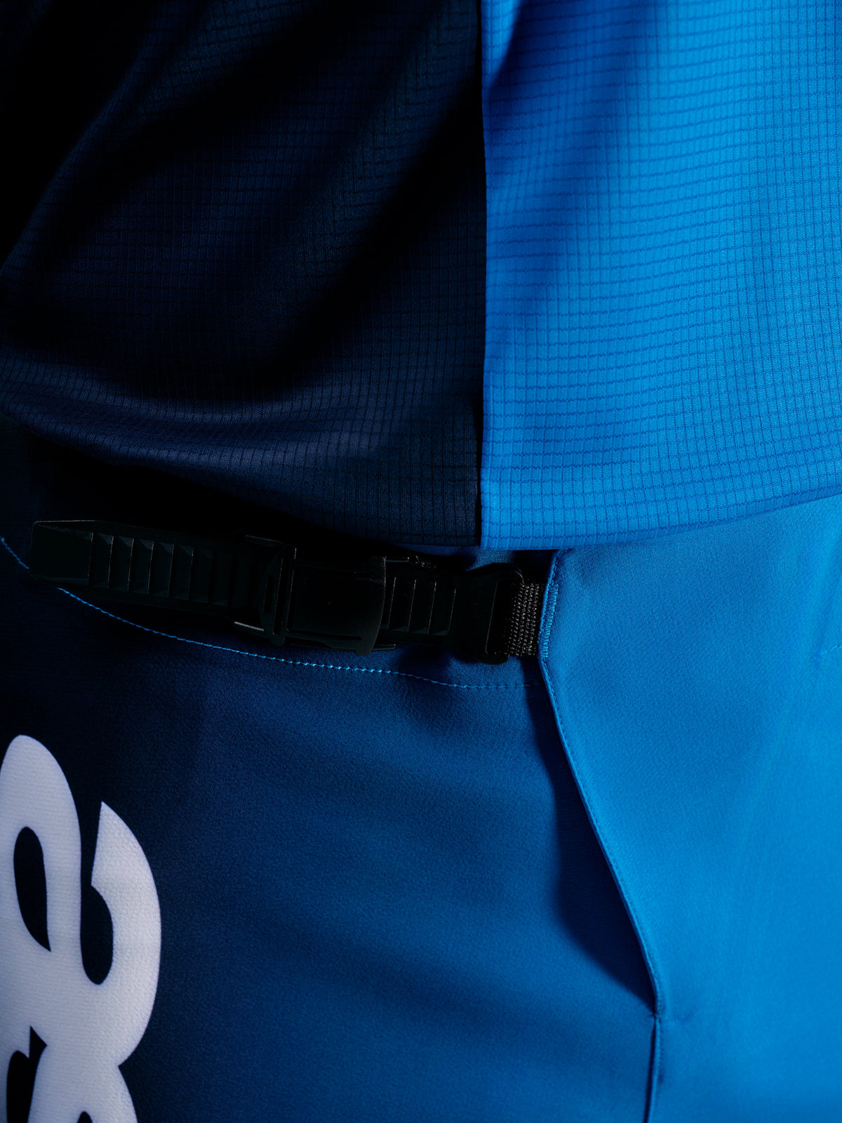A-Supra Elite Pants in Faded Bright Blue, featuring a black ratchet closure system for a secure, adjustable fit on the trail.