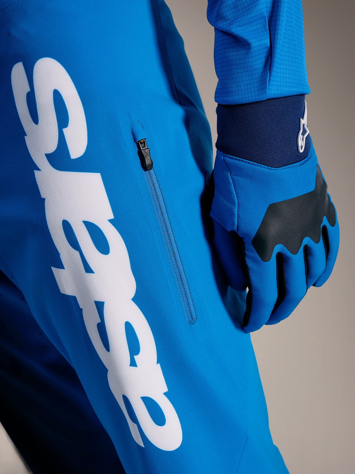 Faded Bright Blue A-Supra Elite MTB Pants featuring a large white Astars wordmark and vertical zippered side pocket.
