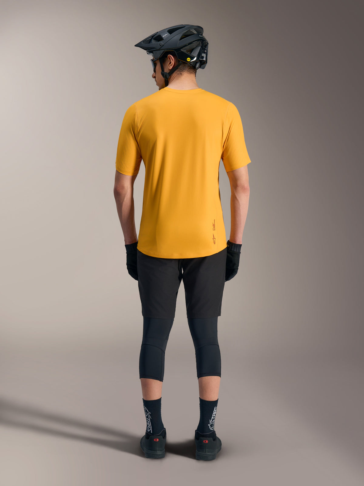 Orange A-Dura Ride Short Sleeve Jersey, back view showing dropped tail and logo detail for casual mountain bike style.