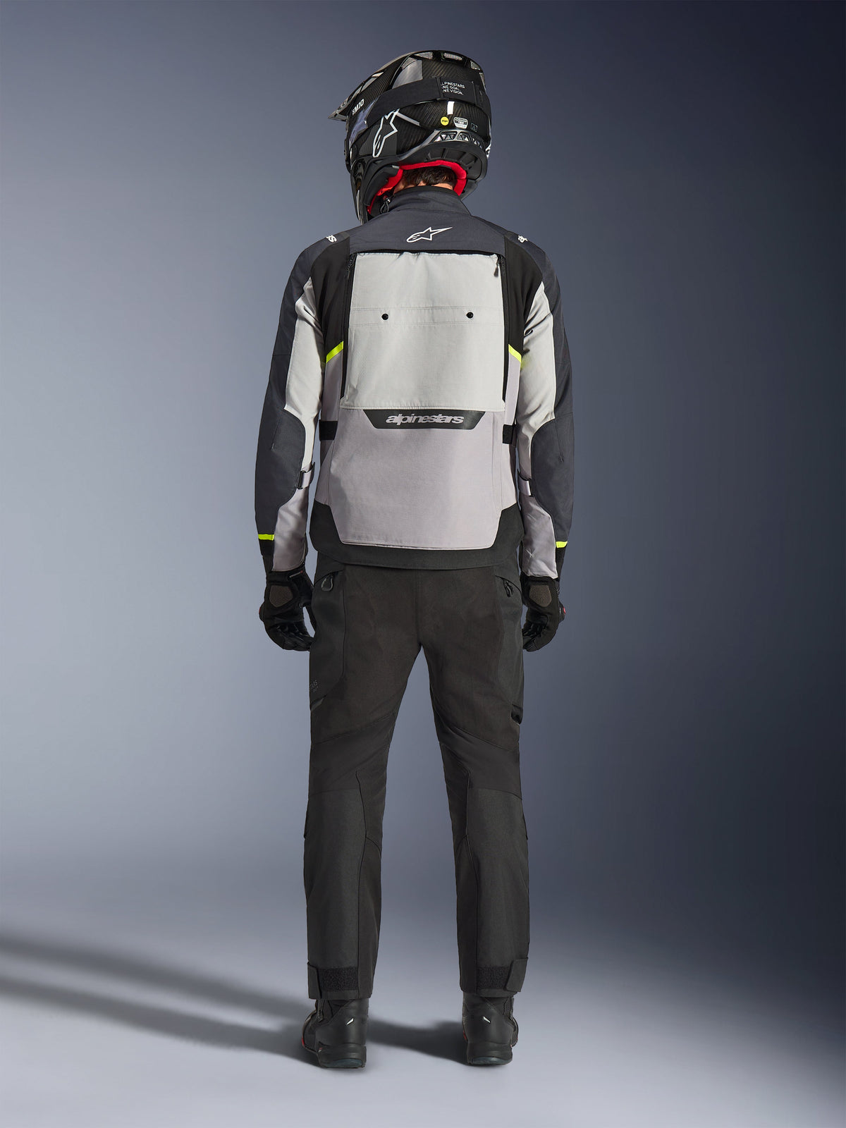 Alpinestars Cusco Drystar® Jacket, men's adventure touring motorcycle jacket in ice gray, mid gray, and deep gray, rear view showing a large back ventilation panel and Alpinestars branding worn by a model in matching gear