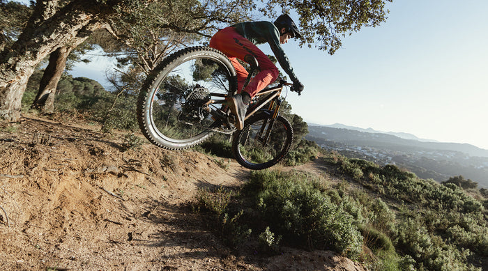 enduro rider jumping on a track on an offroad setting