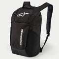 Alpinestars Defcon V2 Backpack, Daily Backpack, Black, featuring white printed logo and vertical Alpinestars branding, front zipper pocket, side mesh pockets, and padded airmesh shoulder straps, durable 600D polyester construction