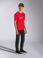 Alpinestars Ageless Shadow CSF Tee, Red Short Sleeve T-Shirt, featuring a large Ageless logo on the chest, worn by a model with black pants and sneakers, casual motorsport streetwear
