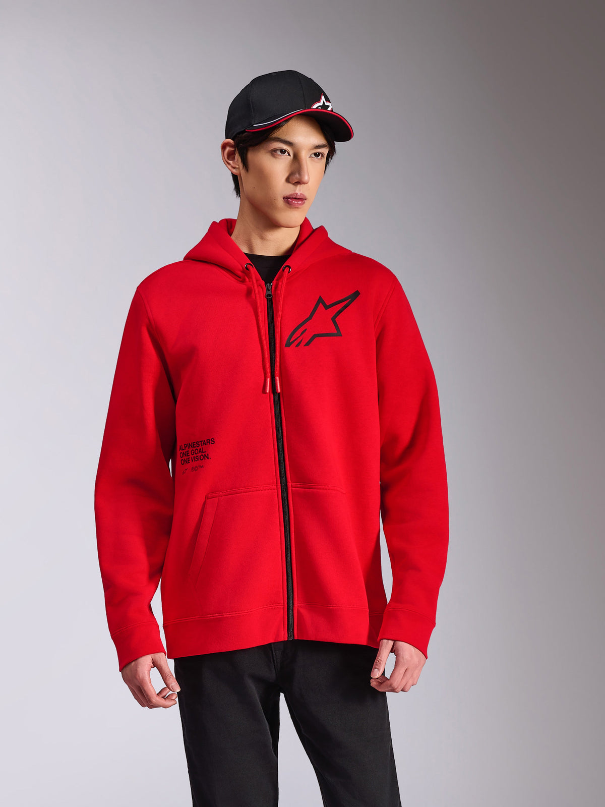 Alpinestars Transverse Hoodie, Red zip-front fleece hoodie, black Astars logo on chest and 'One Goal' print, casual streetwear style worn with a black cap and pants