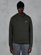 Alpinestars Essentials Ageless Hoodie, casual streetwear, Off Black pullover with a small white Alpinestars logo on the chest, worn with a black beanie, minimalist design with a front pouch pocket and stone-wash finish