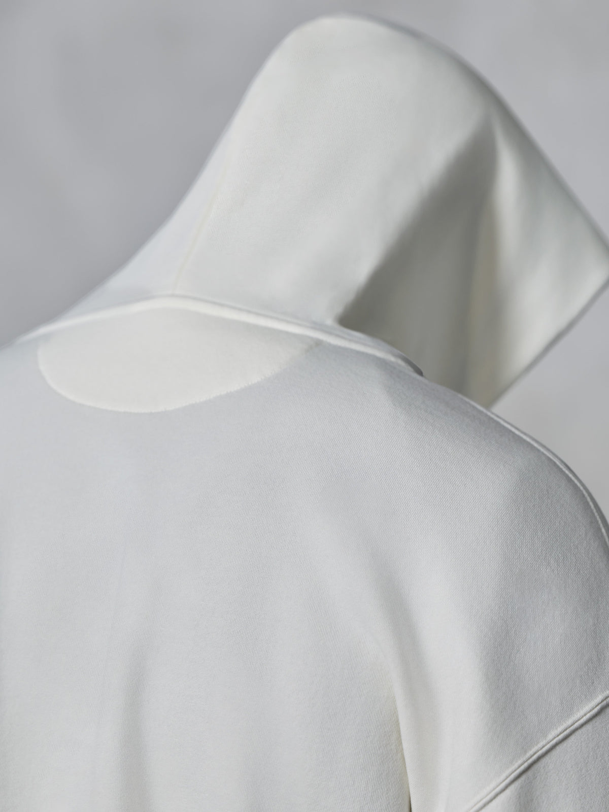 Alpinestars Essentials Ageless Zip Hoodie, Off White, close-up back view of the hood and shoulders, soft compact fleece fabric, minimalist design for casual everyday wear.