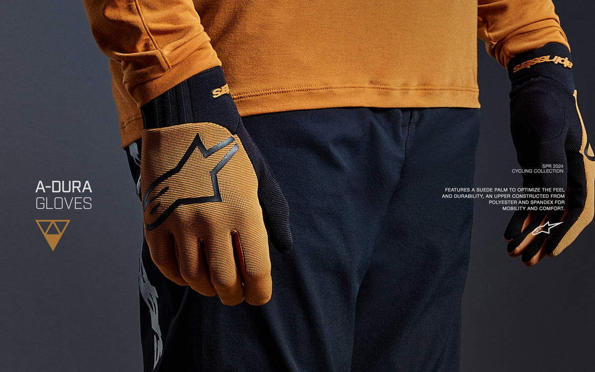 Alpinestars A-Dura mountain bike gloves in dark gold and black, featuring stretch upper and secure neoprene cuffs.
