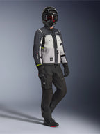 Alpinestars Cusco Drystar® Jacket in Ice Gray, Mid Gray, and Deep Gray, full-body shot of a rider wearing adventure touring gear including a helmet, black pants, and gloves, textile motorcycle jacket featuring direct ventilation panels and waterproof membrane