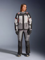 Alpinestars Stella Andes V4 Drystar® Jacket and Pants, women's adventure textile gear set in dark gray, ice gray, black, and coral fluo, front view on a model wearing the complete waterproof riding suit.