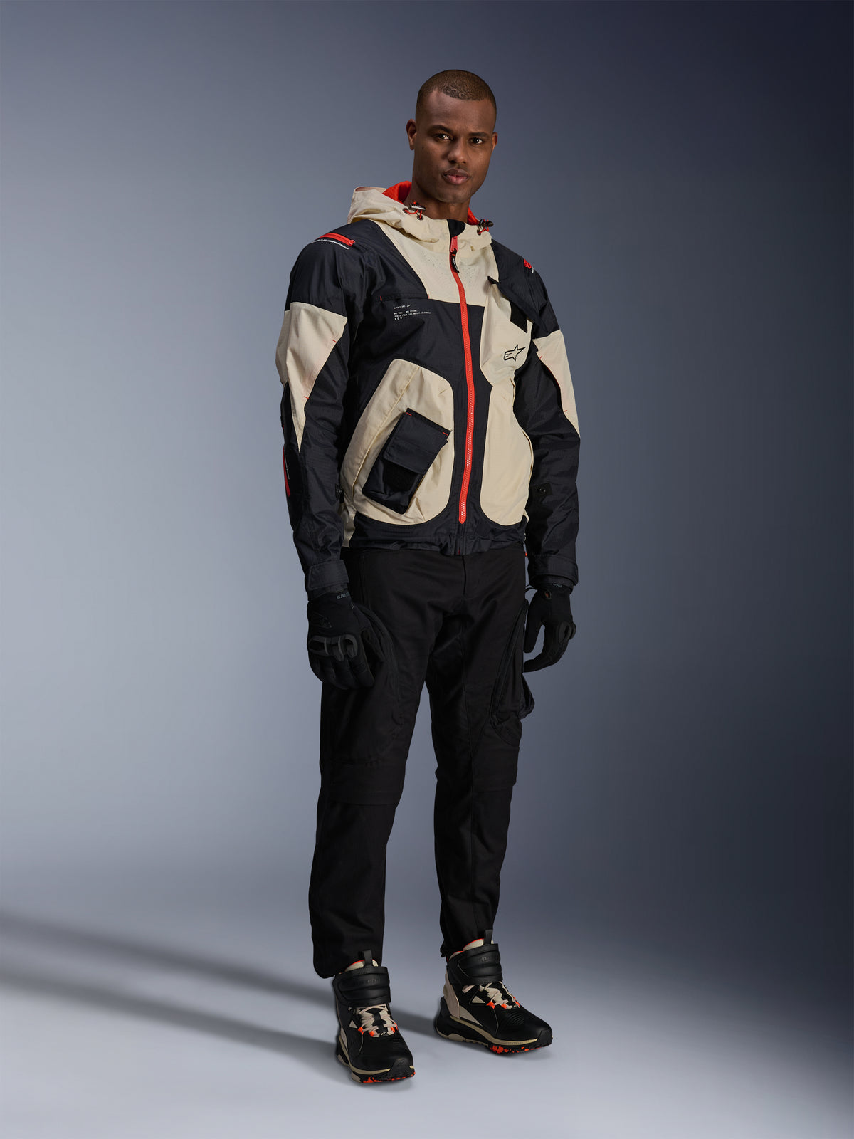 Alpinestars Mogress Air Jacket in Black, Almond, and Hot Orange, an urban textile motorcycle jacket with utility design.