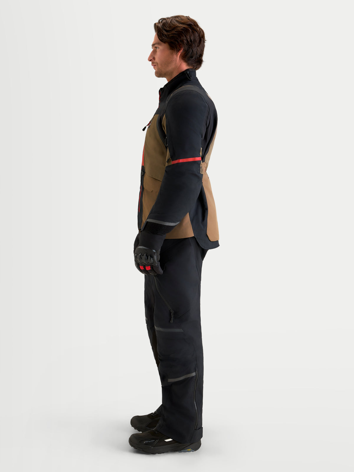 Alpinestars St-7 V2 2L Gore-Tex Gear Set, adventure touring motorcycle jacket and pants, side profile view on a model wearing black and brown waterproof textile riding apparel