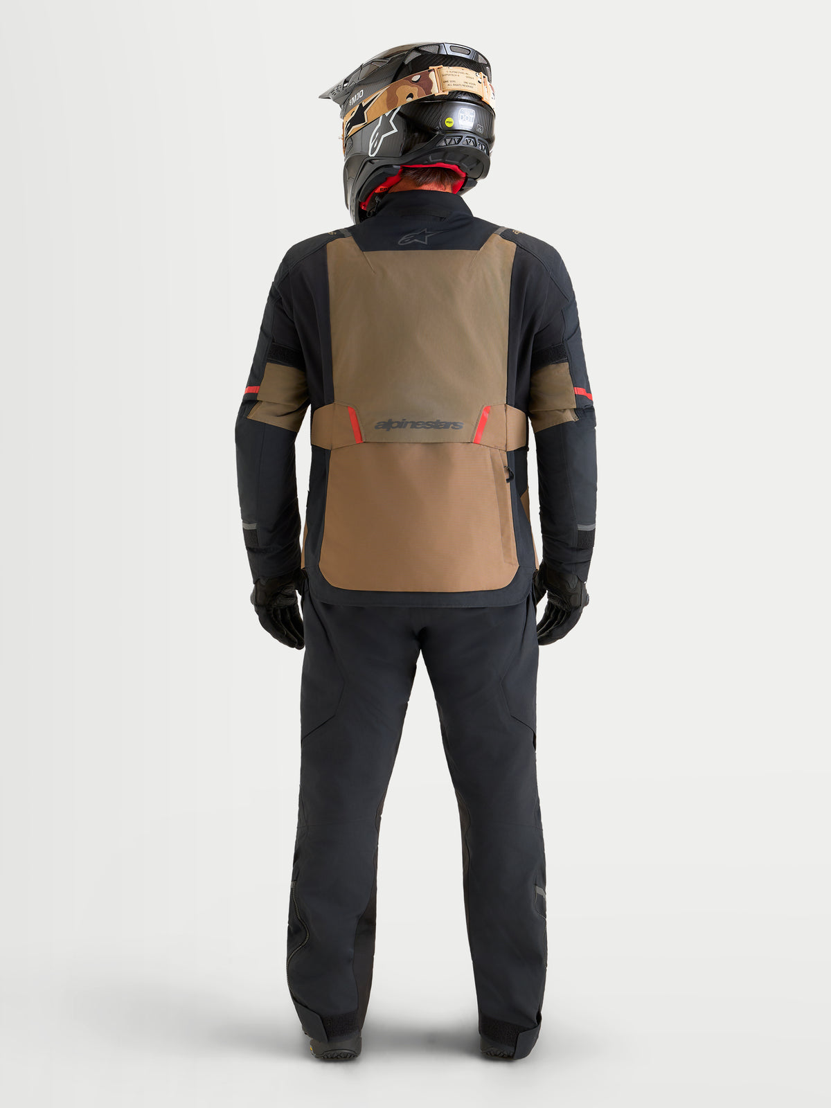 Alpinestars St-7 V2 2L Gore-Tex Gear Set, adventure touring motorcycle jacket and pants in black and brown, rear view on a model wearing matching gear and helmet, waterproof 2-layer GORE-TEX riding apparel