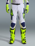 Alpinestars 2026 Racer Air Riway Pants, Motocross Pants, Light Gray Yellow Fluo and Blue, worn with matching neon yellow gloves and boots, featuring perforated front panels for airflow and bold blue and yellow branding, athletic design for off-road performance