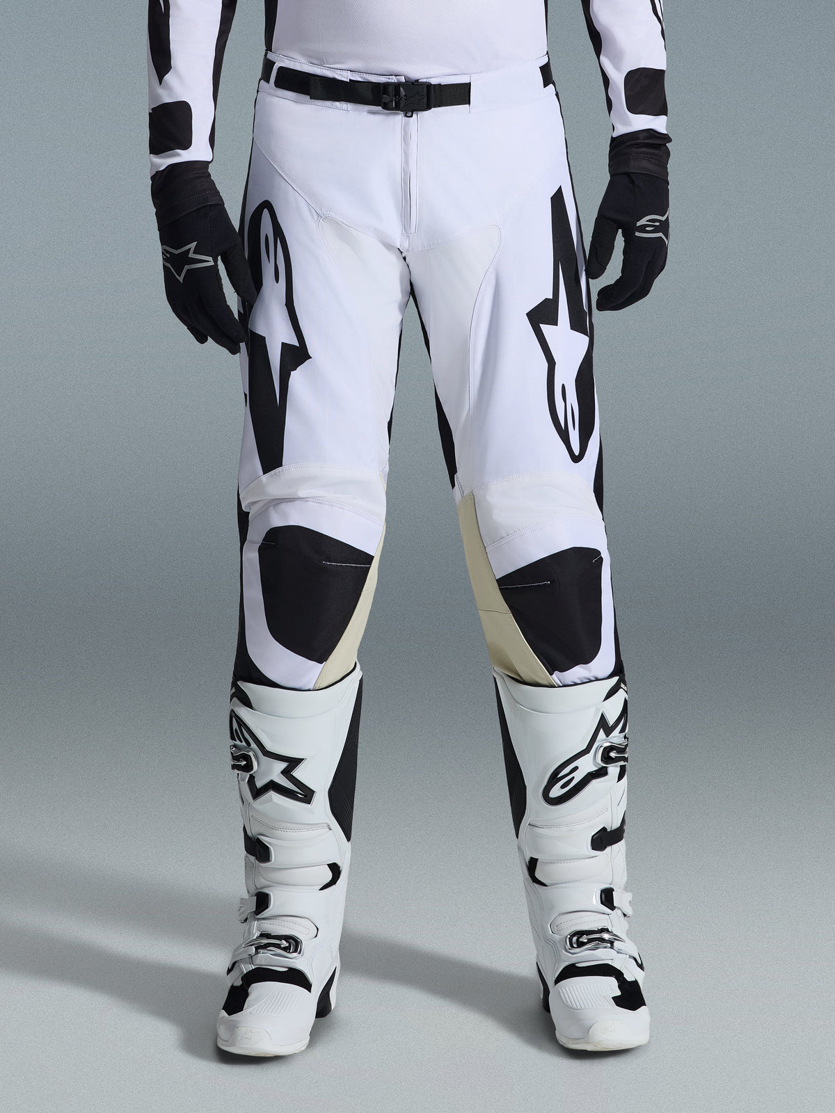 Alpinestars 2026 Racer Riway Pants, Motocross Pants, White and Black, worn with matching white and black motocross boots and black gloves, featuring bold black Alpinestars branding on the thighs, technical design for off-road performance.