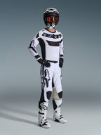 Alpinestars 2026 Racer Riway Pants, Motocross Pants, White and Black, worn as part of a complete racing gear set with matching jersey, boots, and helmet, featuring bold black branding and goat leather inner knee panels, professional off-road racing kit