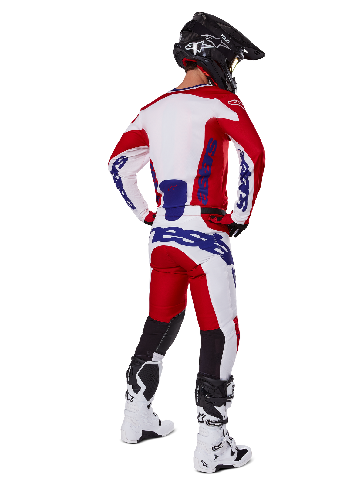 Alpinestars 2025 Racer Veil Pants, Motocross Pants, Bright Red and White with blue accents, shown from behind on a rider in full gear, featuring bold Alpinestars branding, breathable panels on lower legs, and coordinated white boots and black helmet.