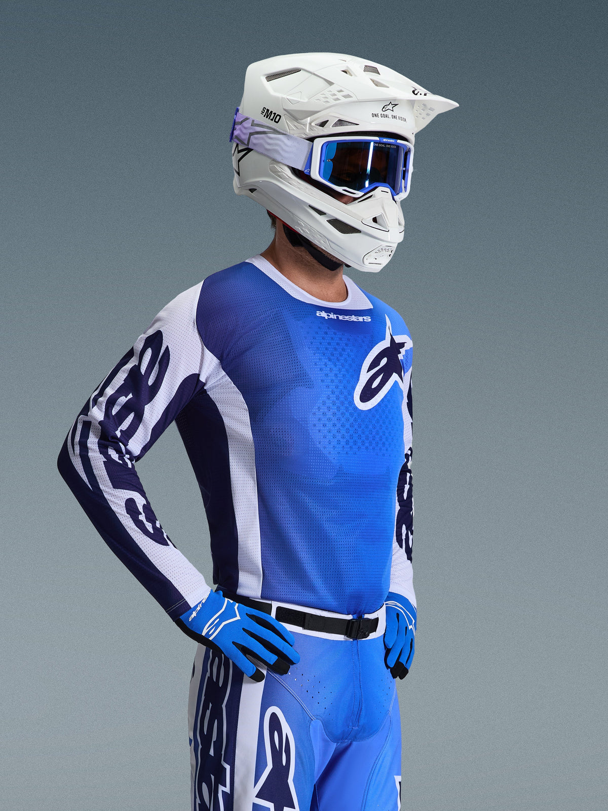 Alpinestars 2026 Racer Air Portl Jersey, Motocross Jersey, Ucla Blue and White, worn with a white helmet, blue goggles, and matching gloves, featuring a breathable mesh design for high-temperature off-road racing.