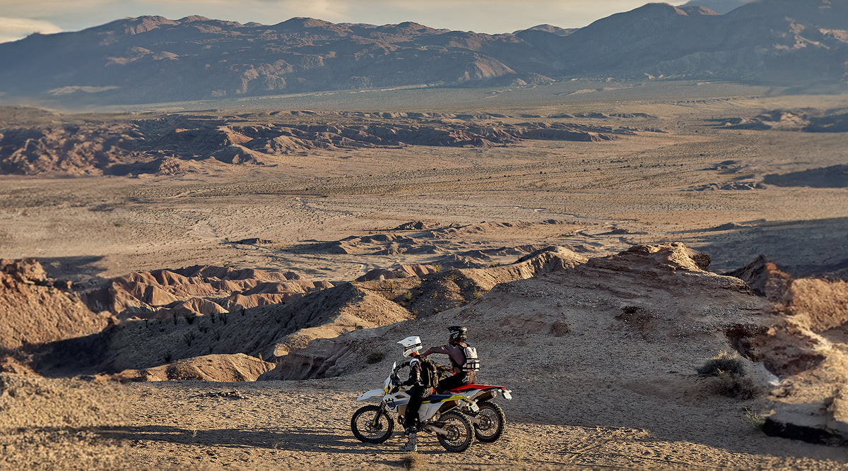Alpinestars Techdura Gloves, off-road enduro motorcycle gear, men's, black and brown, in a desert canyon landscape.