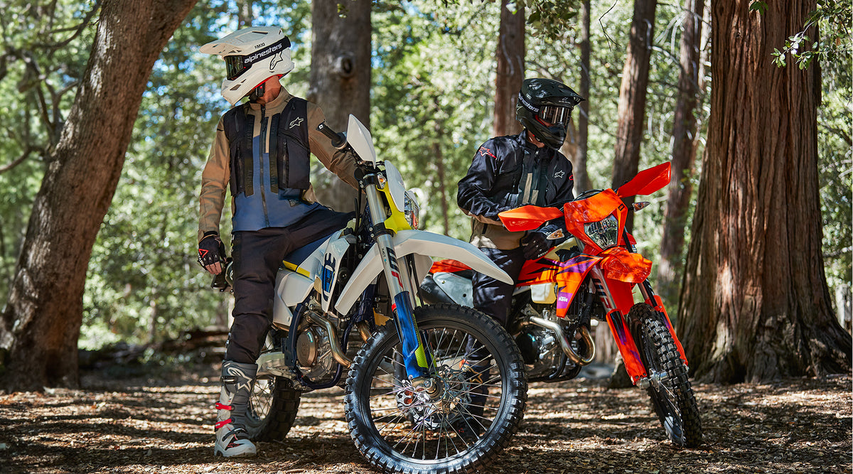 Alpinestars Techdura Pants in Black, rugged stretch motorcycle trousers for enduro and off-road riding in a forest.