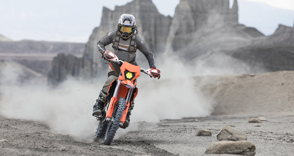 Alpinestars Maxdura Dual Jersey and Pants, motorcycle adventure gear in gray and walnut, off-road riding in desert terrain.