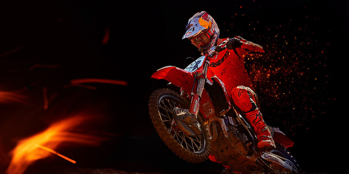 Alpinestars Limited Edition Supertech Ember Pants, red fluo and black motocross gear, worn by a rider in action.