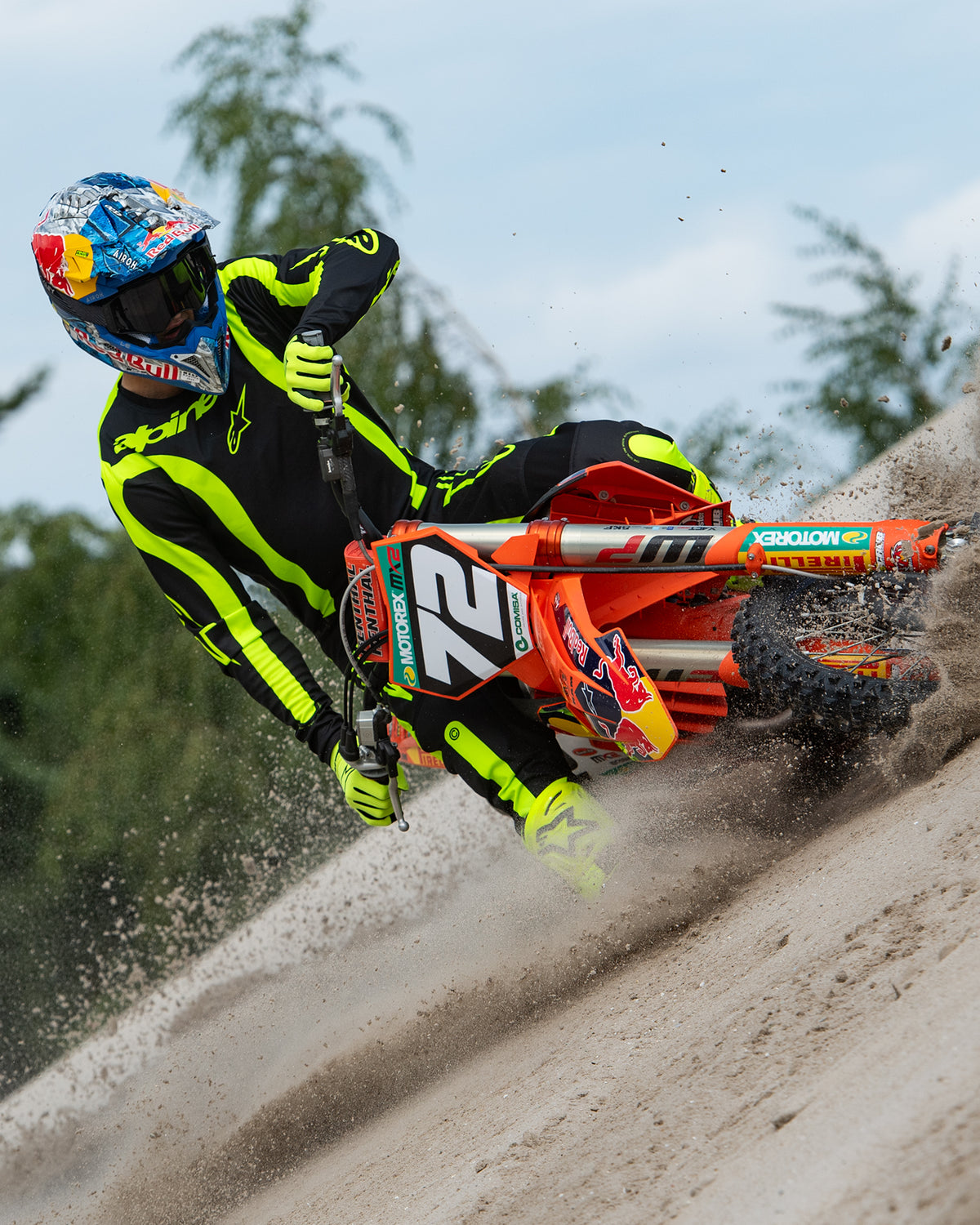 Alpinestars 2024 Fluid Lurv Jersey, Black and Yellow Fluo motocross racing jersey shown in action on a sand track.