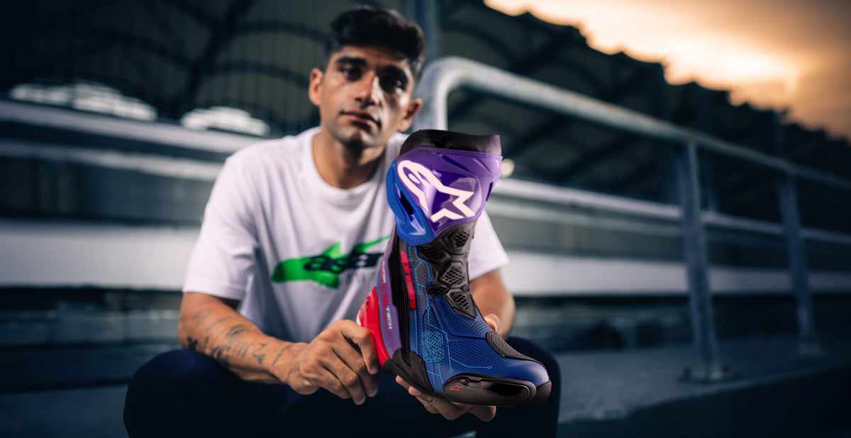 Alpinestars Limited Edition Supertech R Martinator R01 Vented Boots, blue and purple racing boots held by a rider.
