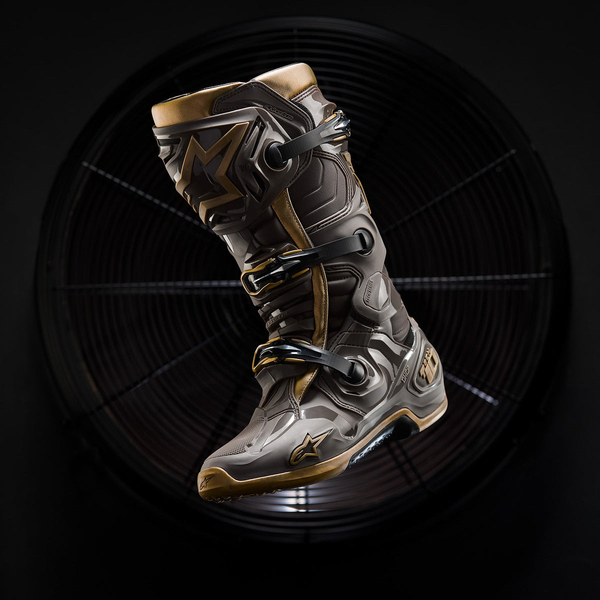 Alpinestars Tech 10 Air Gold motocross boots in Earth Brown and Gold, featuring a protective TPU shell and ventilated design.