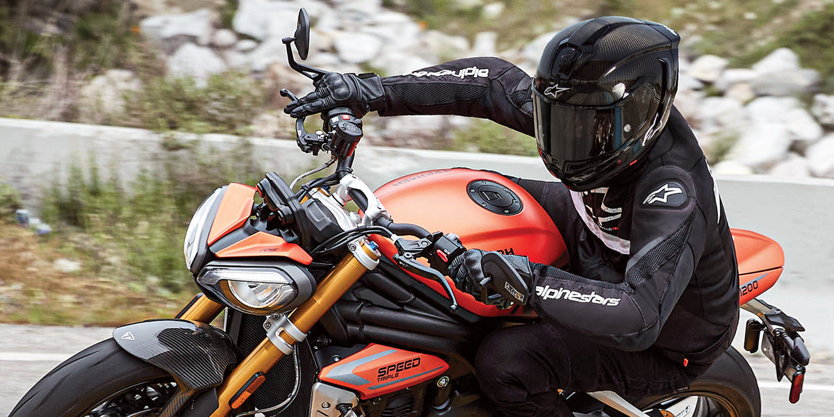 Alpinestars T-GP Plus R V4 Airflow Jacket, black ventilated textile sport motorcycle jacket for men riding on a road.