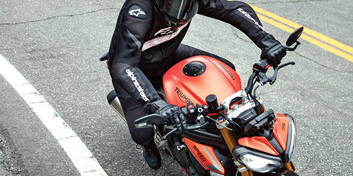 Alpinestars T-GP Plus R V4 Airflow Jacket, Men's Black textile sport riding jacket, worn by a motorcyclist on the road.