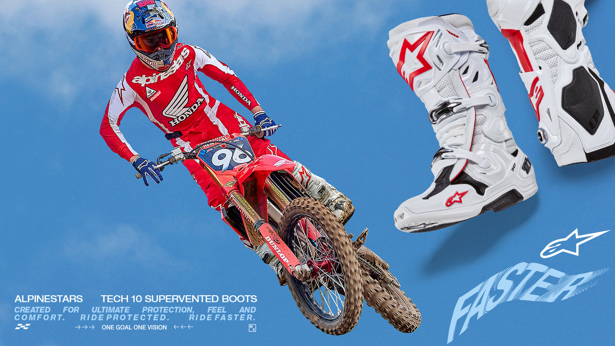 White and red Alpinestars Tech 10 Supervented Boots shown with a motocross rider mid-jump on a red dirt bike.