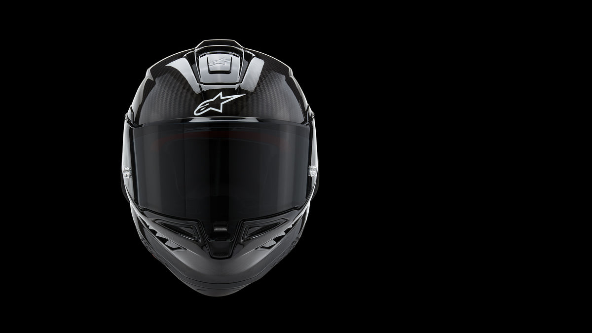 Alpinestars Supertech R10 Motorcycle Racing Helmet, Carbon Fiber Shell, Black and White, with dark visor and aerodynamic vents.
