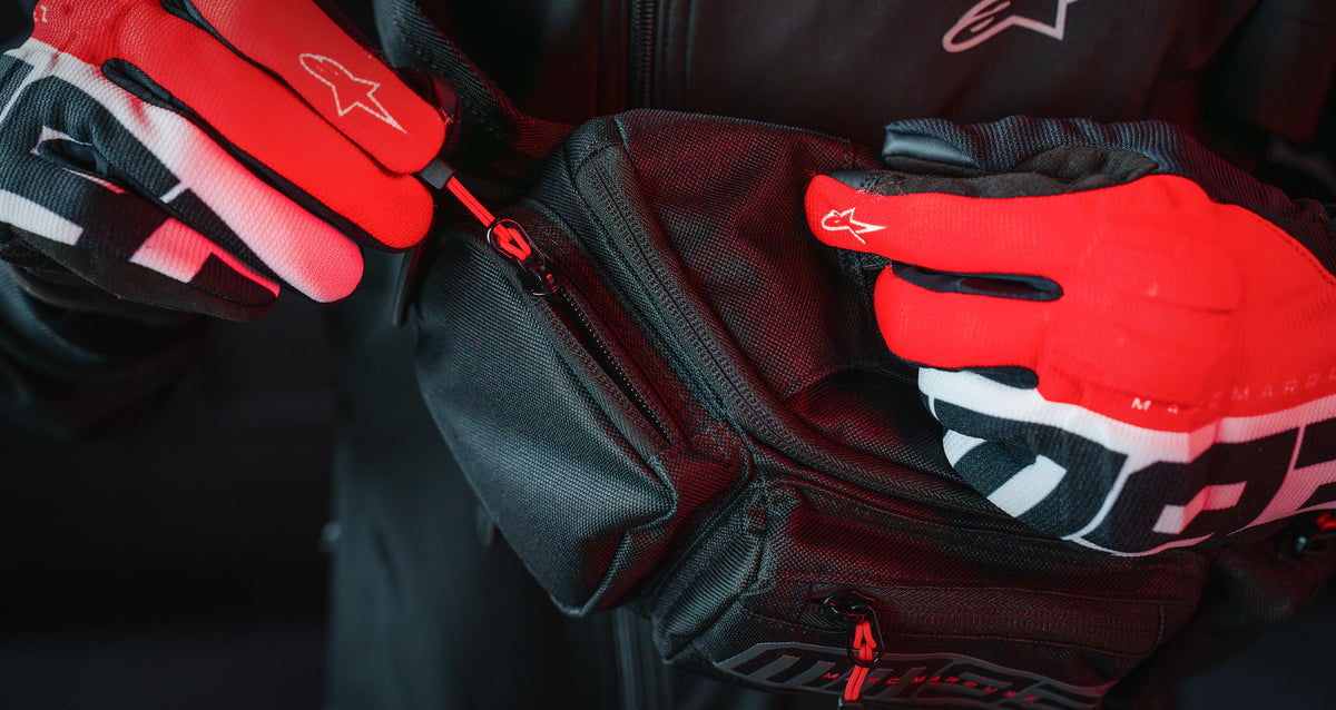 Alpinestars MM93 Waist Bag, motorcycle racing hip pack, black textile with red accents, Marc Márquez collection branding.