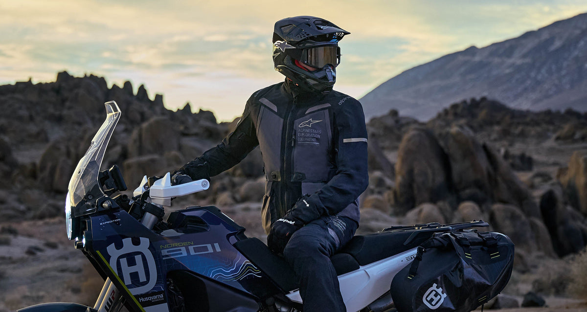 Alpinestars ST-7 2L GORE-TEX Jacket, adventure touring jacket in Deep Gray and Black, on a rider in a rocky desert landscape.