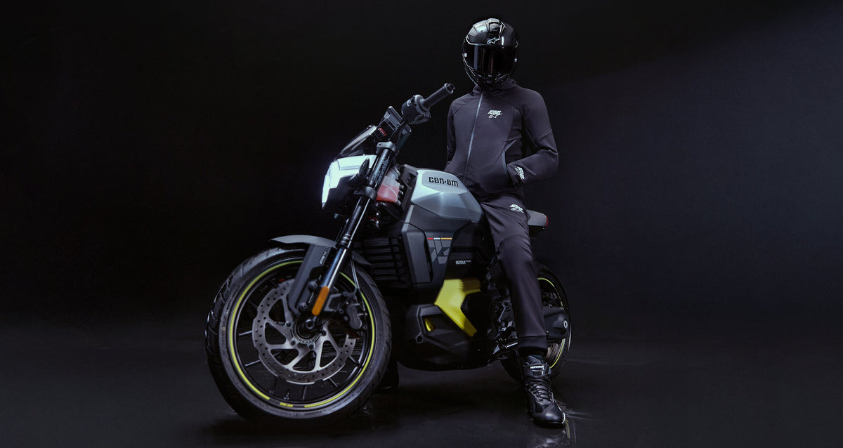 Alpinestars Aeroshell Pants, black softshell motorcycle road pants, styled on-model with a performance bike.