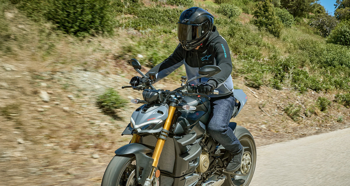 Alpinestars Chrome V2 Sport Hoodie, gray and black urban motorcycle hoodie, worn by a man riding on an open road.