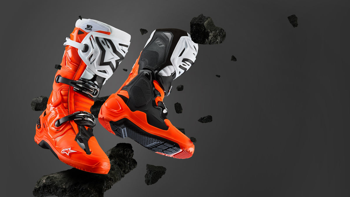 Alpinestars Tech 10 Enduro Boots in orange, black, and white, professional motocross boots for off-road racing performance.