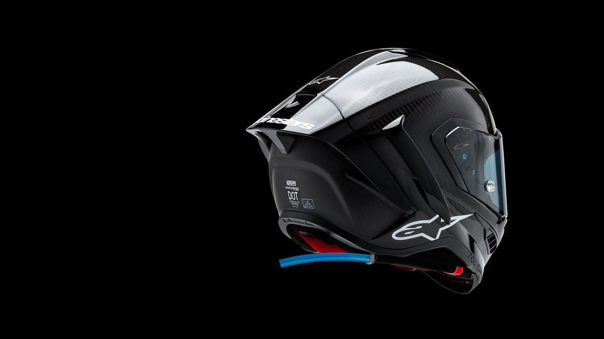 Alpinestars Supertech R10 Helmet, Motorcycle Racing, Black Carbon Fiber, Size M, DOT Certified, featuring a blue hydration tube.