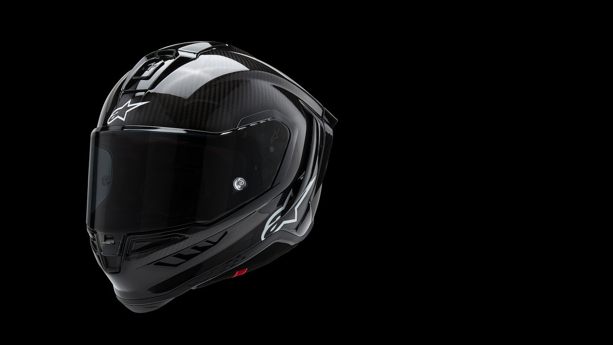 Alpinestars Supertech R10 Carbon Helmet, full-face motorcycle racing helmet in glossy black carbon fiber with a tinted visor.