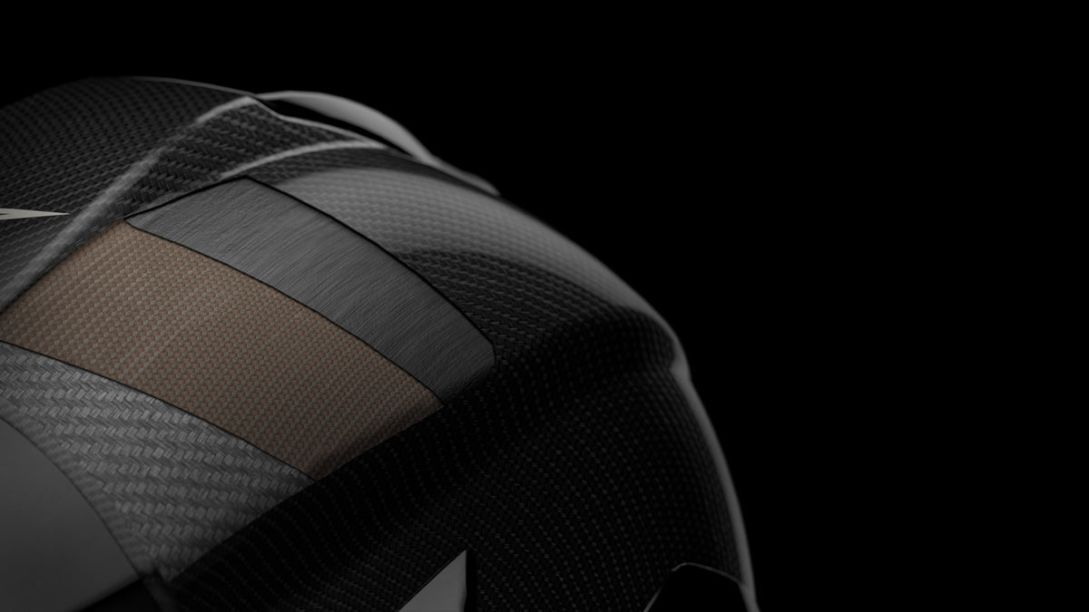 Alpinestars motorcycle helmet, racing protection shell, black and copper, carbon fiber construction with premium weave detail.